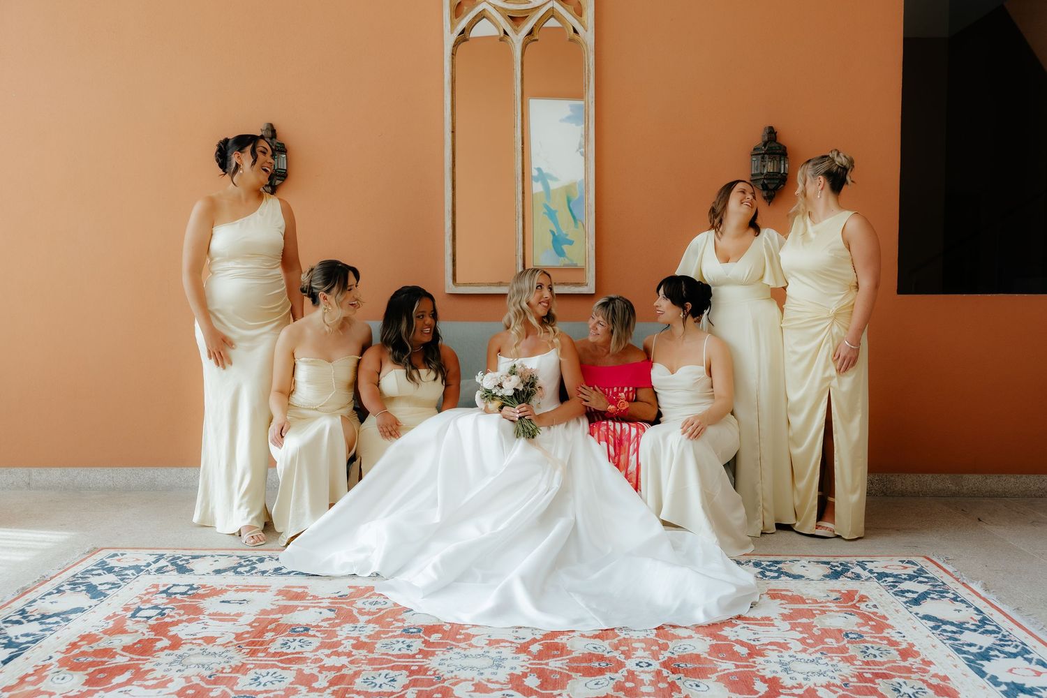 A sequence of wedding preparation moments showing white dresses and gowns in a peach-colored room.