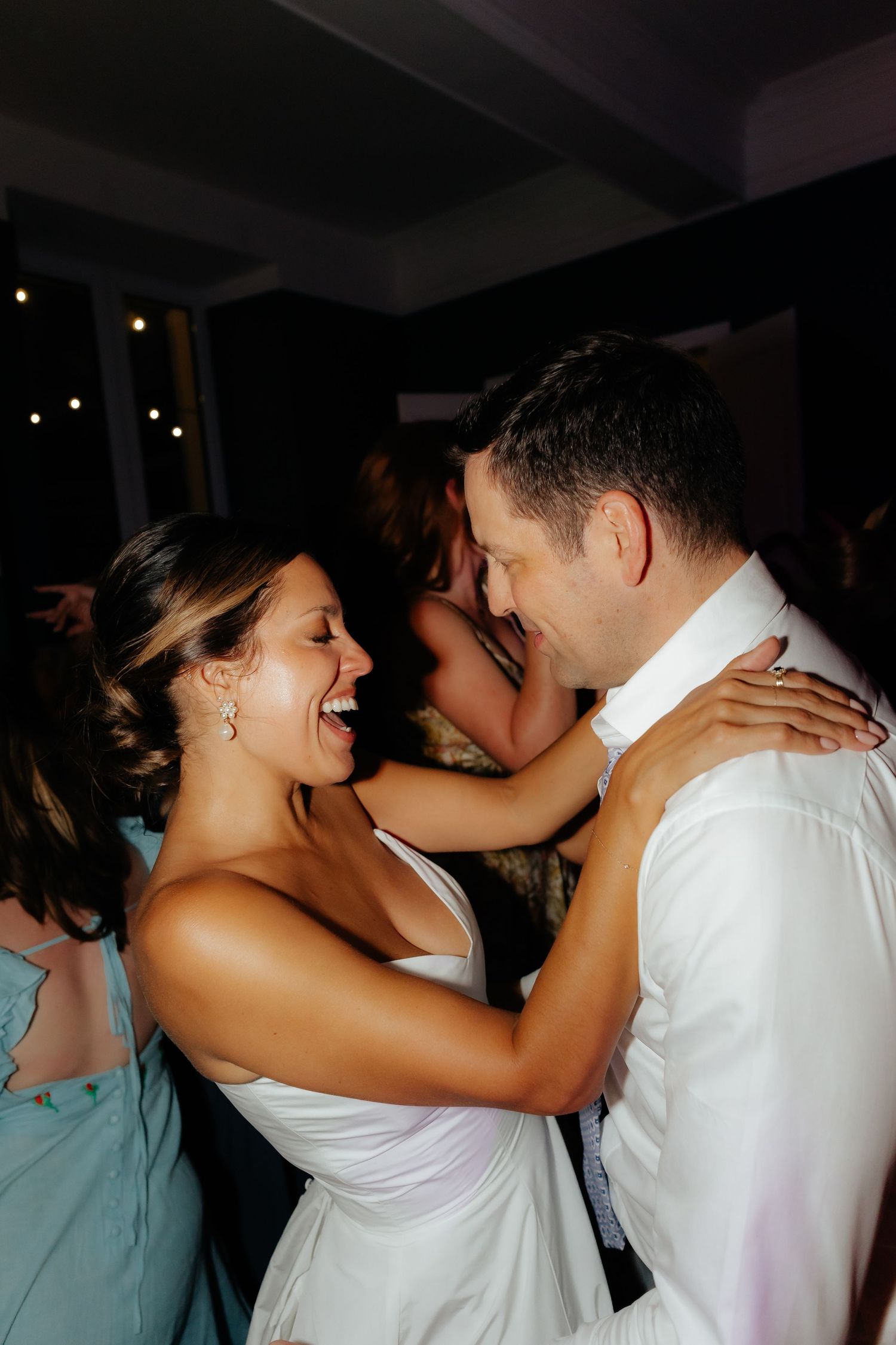 Wedding couple embraces on the dance floor during their first dance.