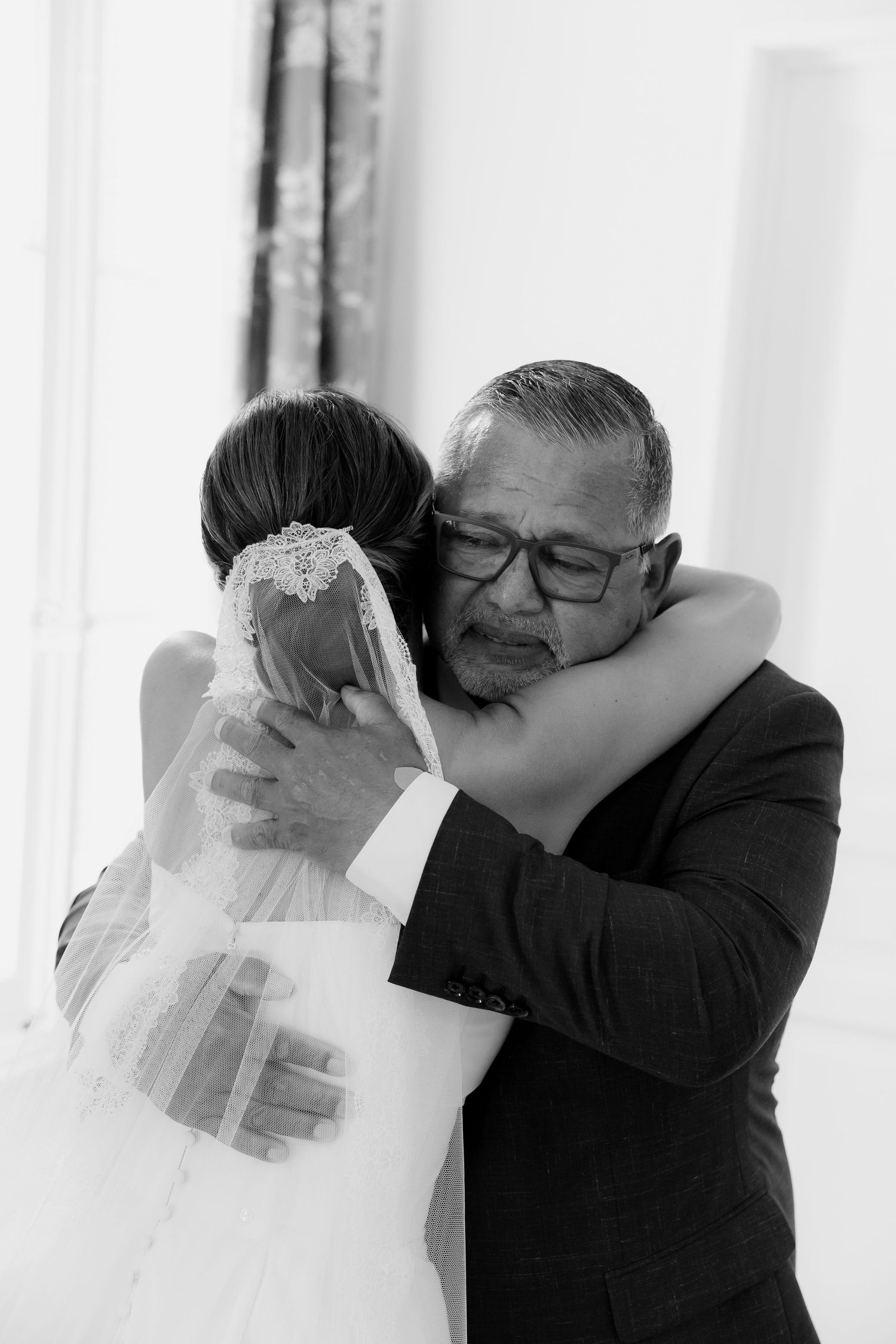 Emotional black and white sequence of a tender embrace between bride and loved one.