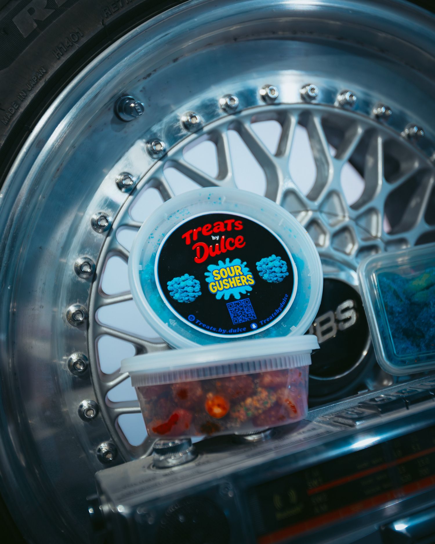 CoCo Event Group's Y2K Car Meet Up, product shots of Treats By Dulce propped on BBS RS