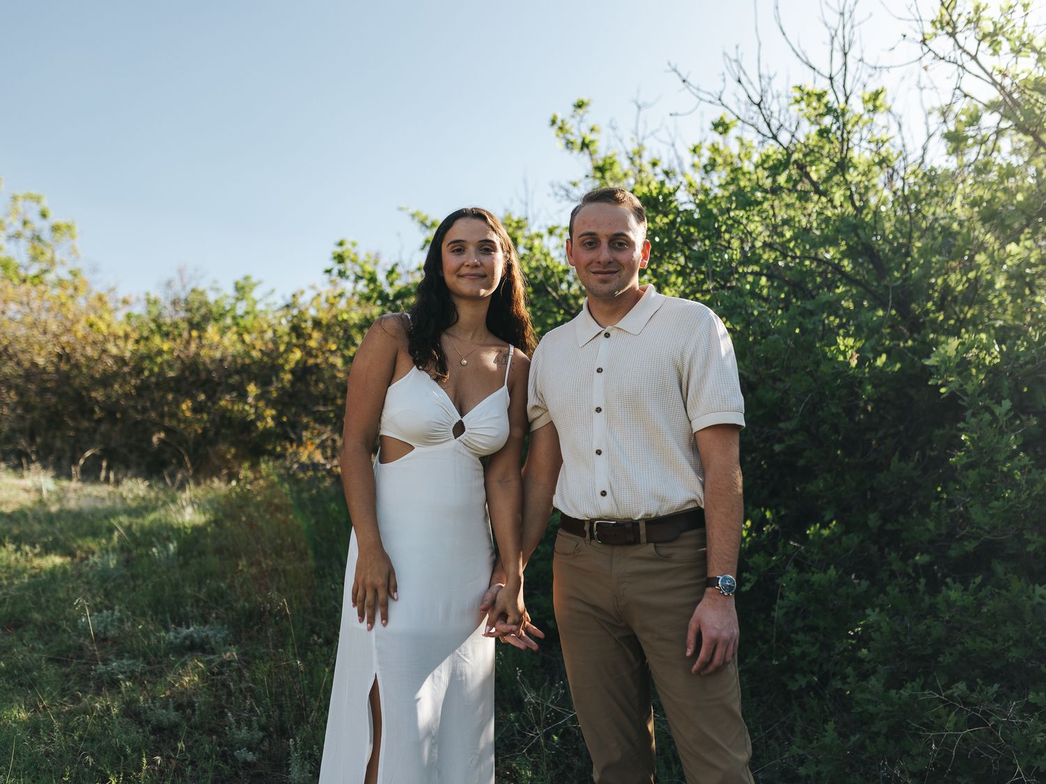 Couple holding hands side by side during golden hour at South Valley Park