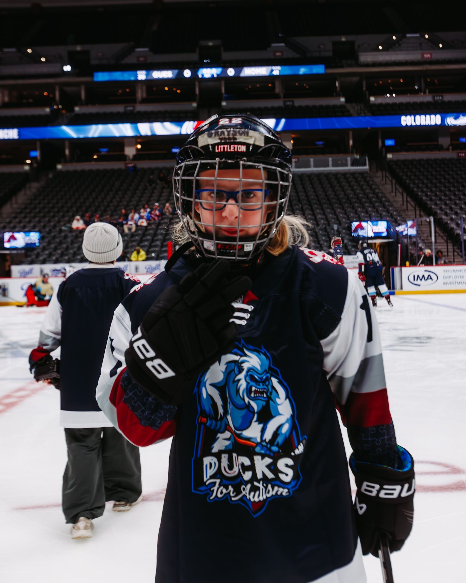 Close up of player, with Pucks For Autism gear at Ball Arena