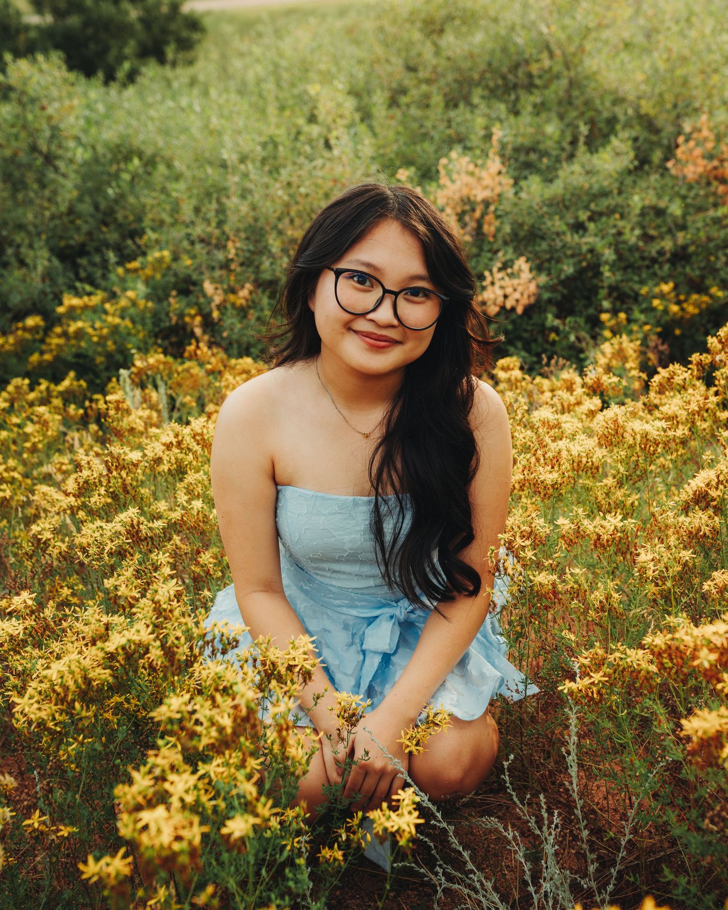 Senior portrait posing in a bed of flowers, Colorado senior photography