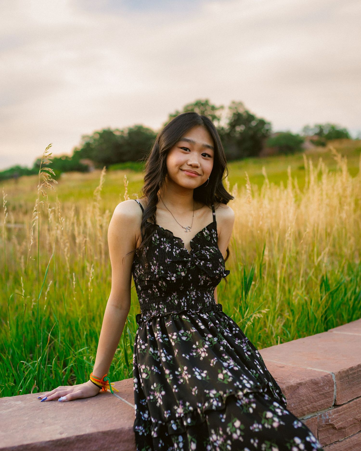 Senior portrait leaning back with tall grass at South Valley Park in Colorado