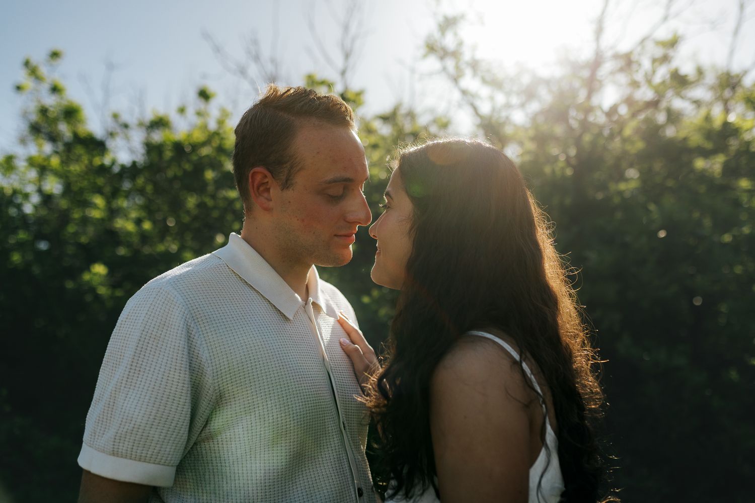 Couple posing, looking into each other's eyes during sunrise golden hour at South Valley Park
