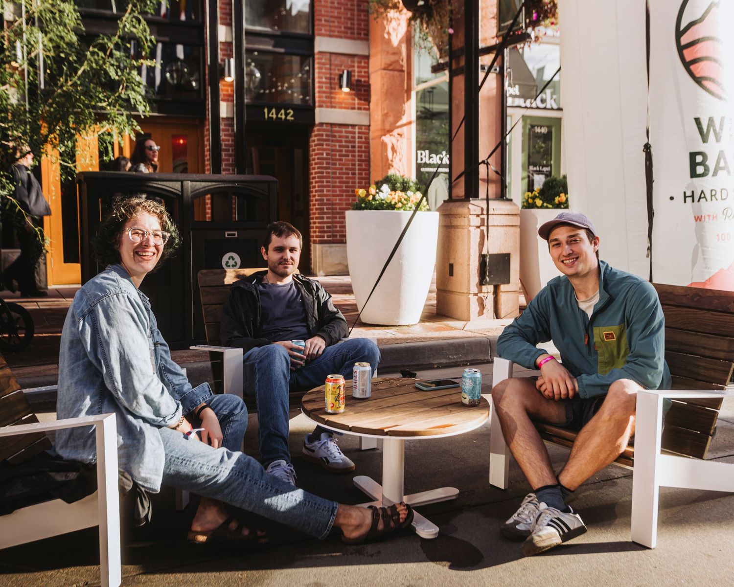 Group of friends, sitting during sunset, enjoying Larimer Square during Beer Block Festival, Downtown Denver