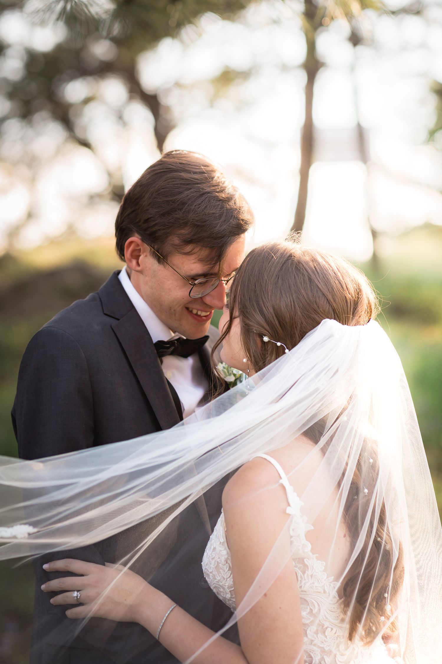 Krause Wedding, bride and groom posing for wedding photos, embracing each other during sunset at Botecher Mansion, in Colorado