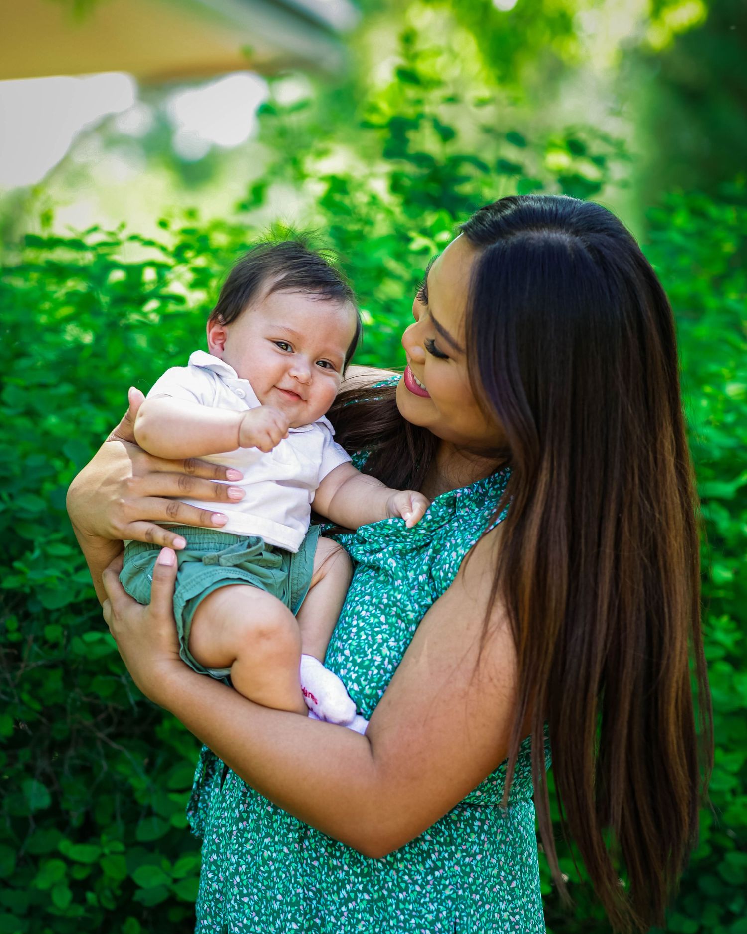 Mother holding and laughing with her child at the Denver Botanic Gardens