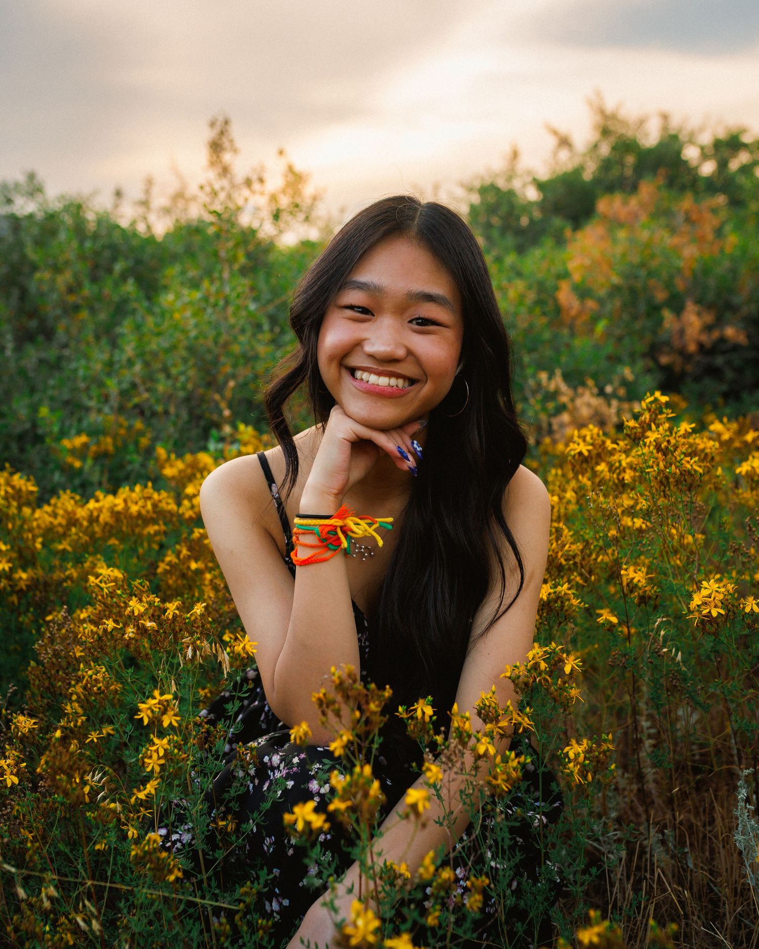 Senior smiling in a bed of flowers at South Valley Park in Colorado