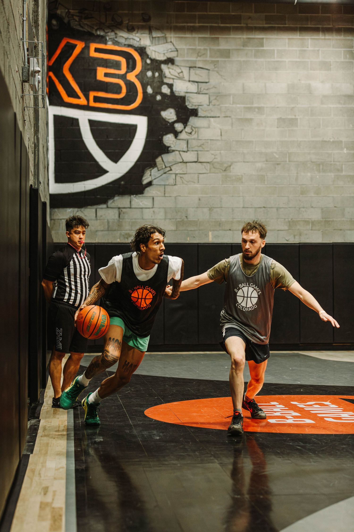 Player driving to the basket, past a defender during a game at Basketball Social House, COCO Event Group's Jam Fest