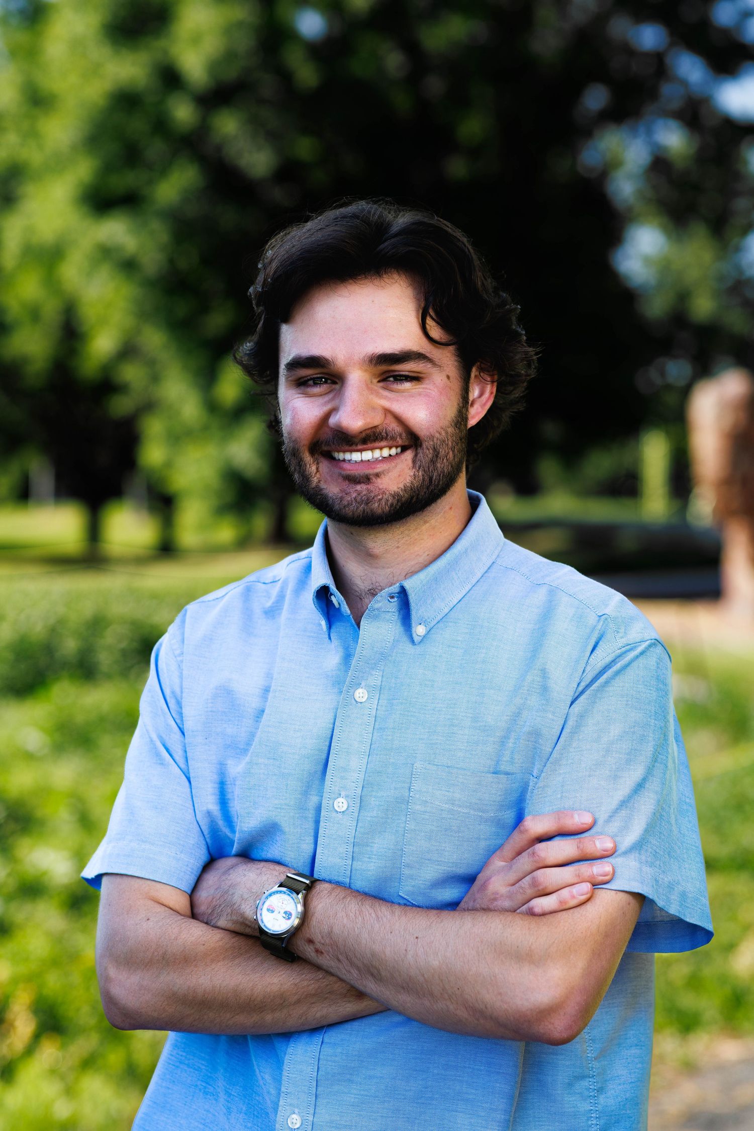 Portrait with arms crossed, trees in the background at Rosamond Park