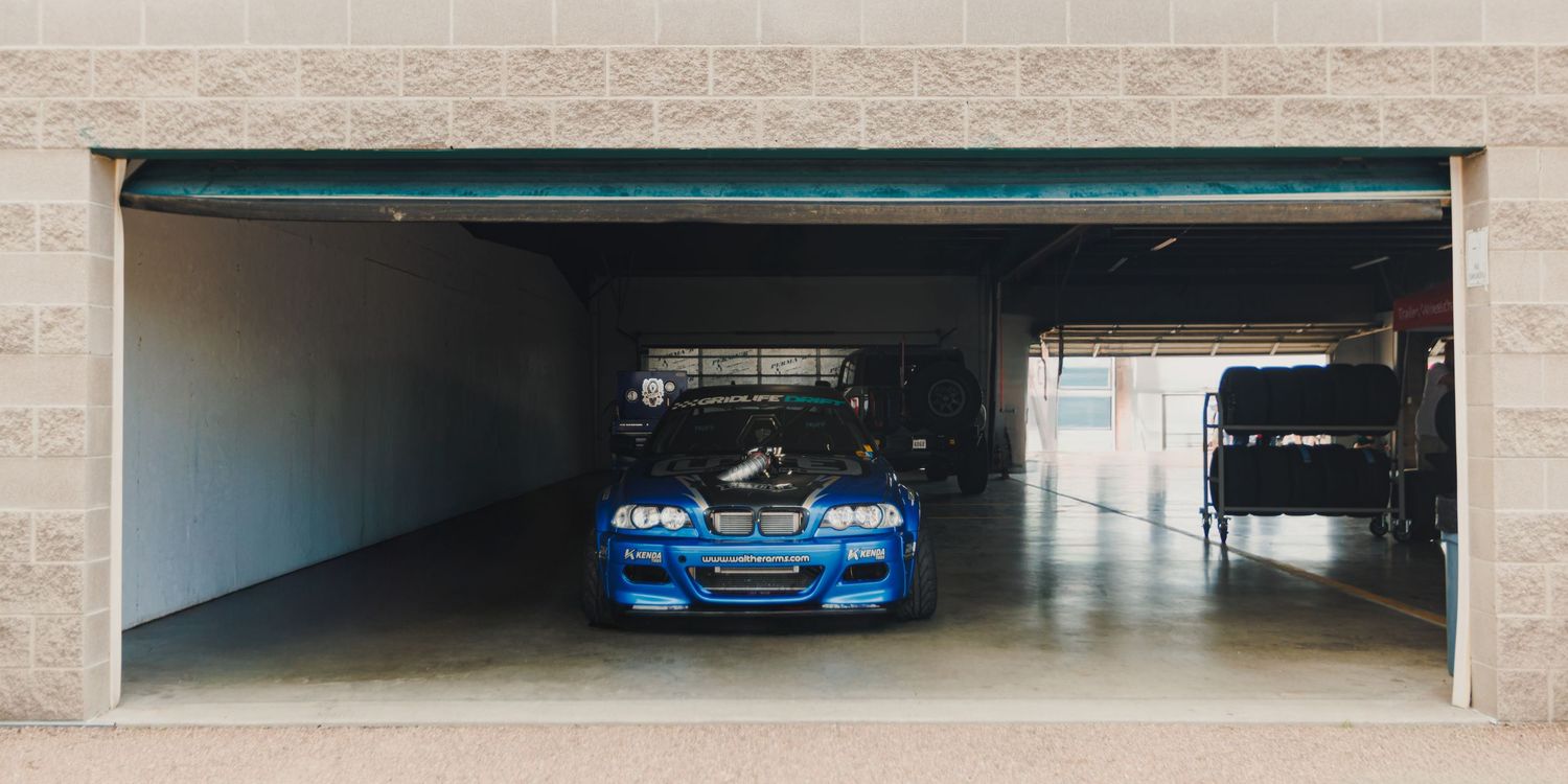BMW e46 being prepped in a garage before drifting session at Down To Earth Movement Ascend in Pikes Peak International Raceway