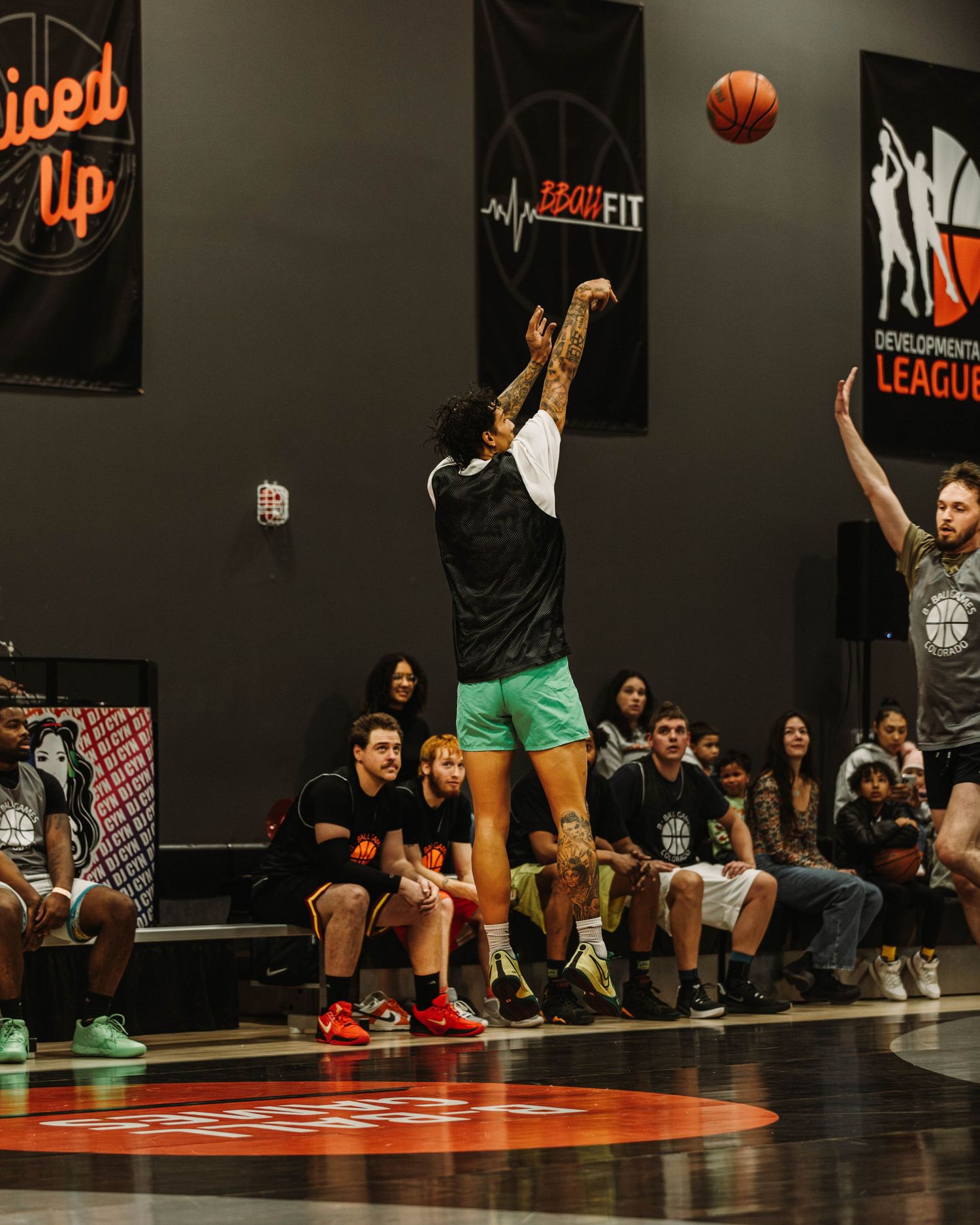 Player shooting a basketball from half court during a game