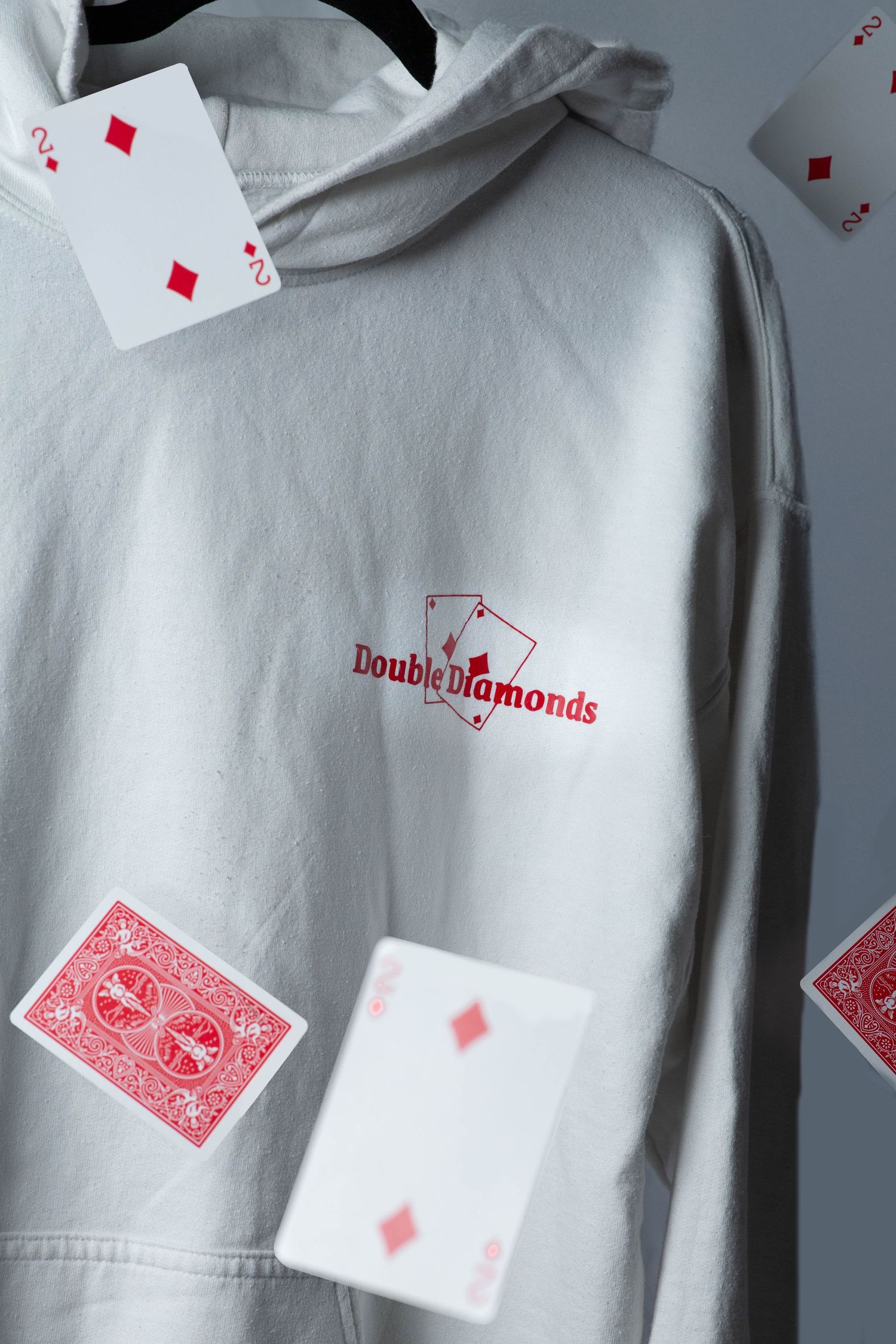 Close up, creative product shot of Double Diamonds, double aces white hoodie