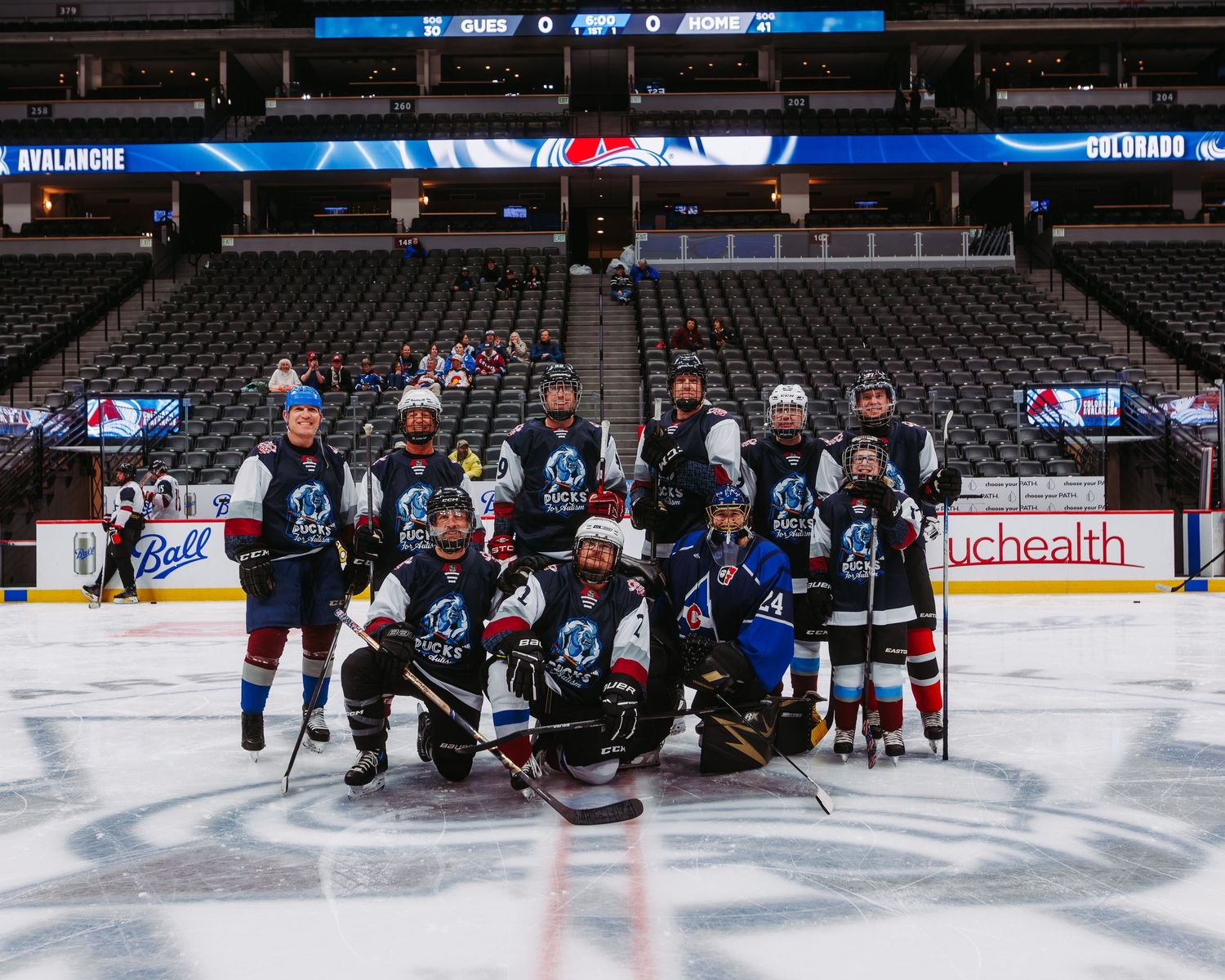 Team photo for Pucks For Autism, Colorado Avalanche charity after game at Ball Arena