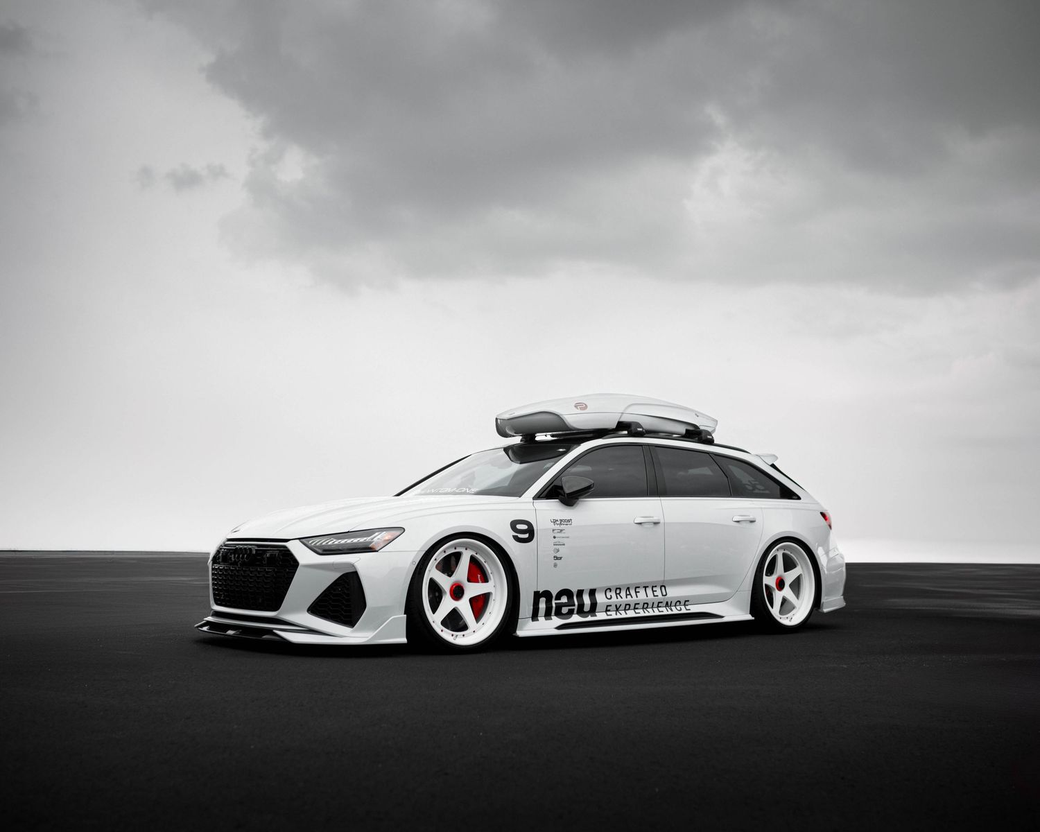Stanced and bagged, White Audi S6 Avant during cloud coverage at Wings Over the Rockies Air & Space Museum