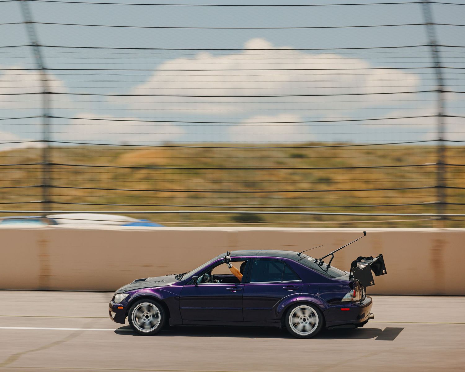 Medium shot of a track purposed Lexus is300, speeding down Pikes Peak International Raceway in Colorado Springs, Colorado