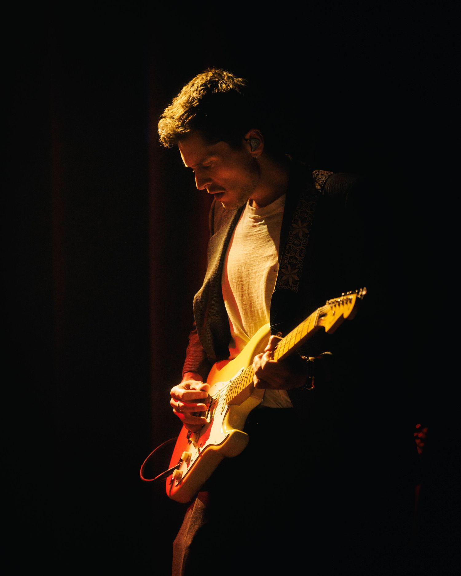 Dramatic lighting, guitarist for Sawyer Hill, performing at Bluebird Theater in Denver, Colorado