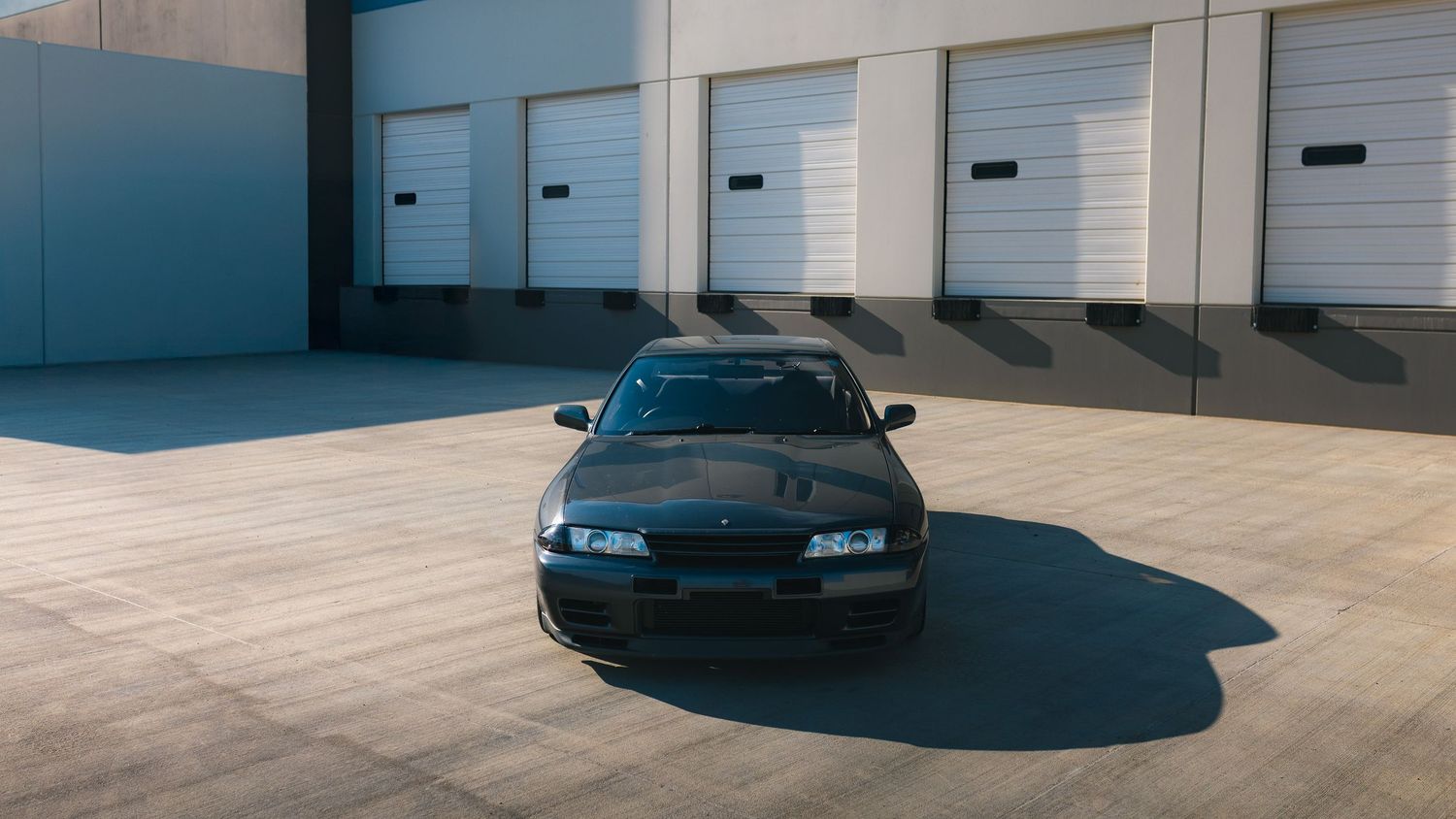 Wide angle shot of a 1990 Nissan Skyline GTR R32 at a warehouse near Deer Creek Canyon, Denver, Colorado