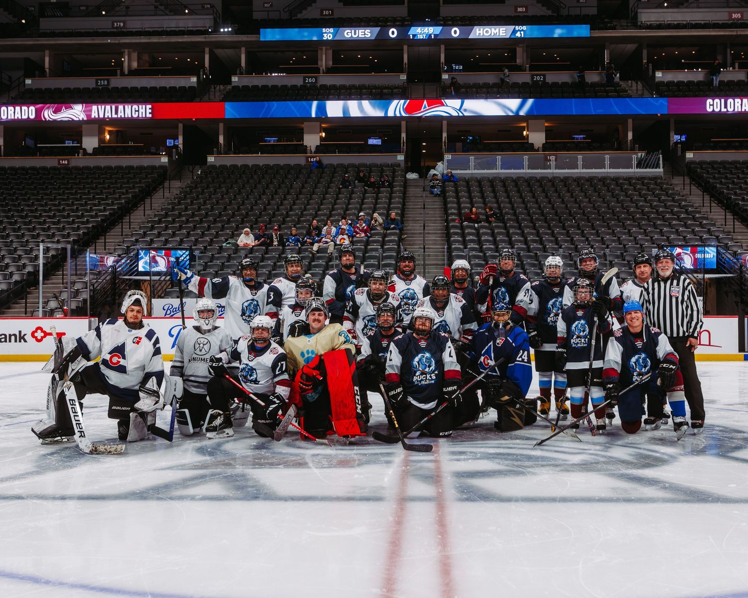 Group photo of all players at the 2026 Pucks for Autism x Goalie Guild game at Ball Arena