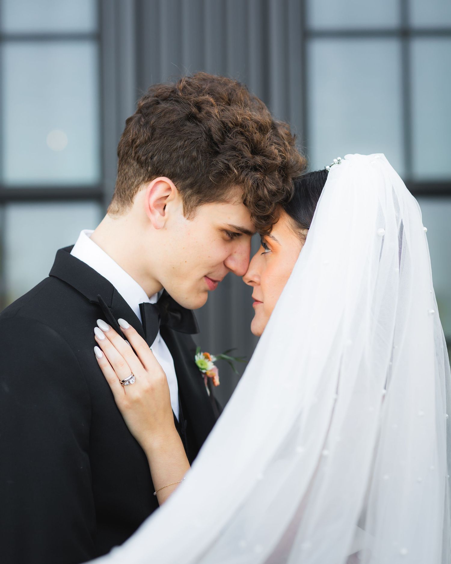 Storrie/Longoria Wedding, newly wedded couple, posing with each other, while touching foreheads at The Windsor Mill Event Center