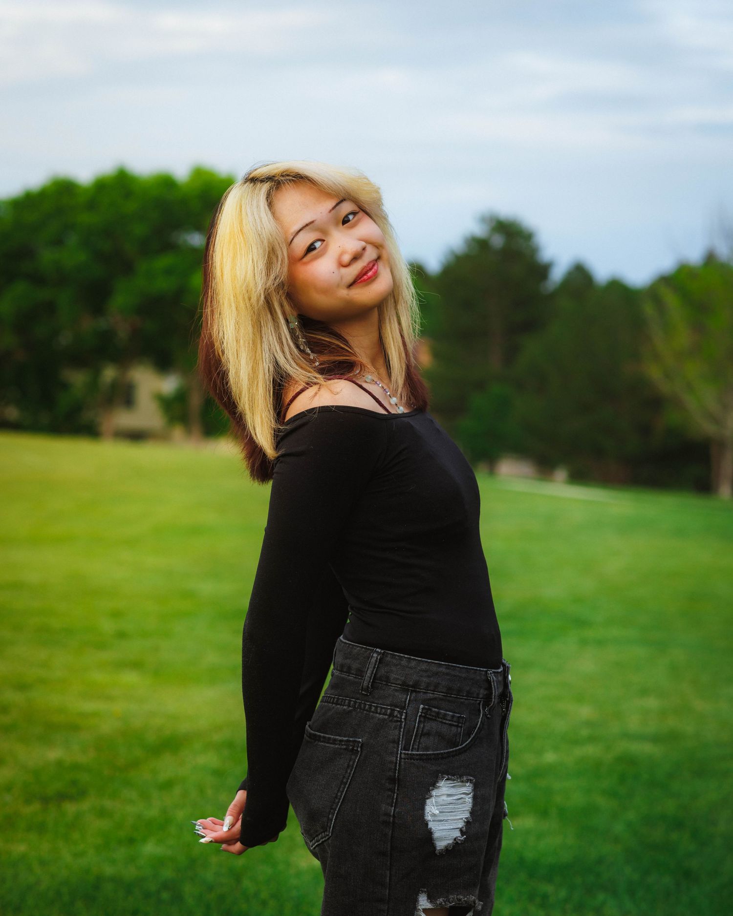 Senior portrait posed with open field in the background at Arapahoe Park