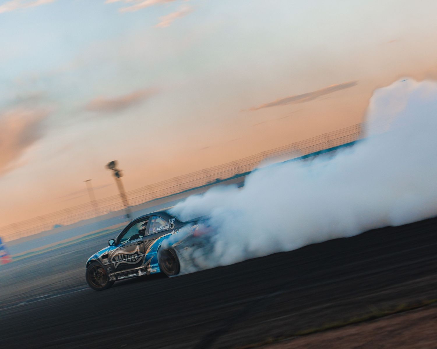 BMW e46 drifting during sunset at Down To Earth Movement Ascend in Pikes Peak International Raceway, Colorado Springs, Colorado.