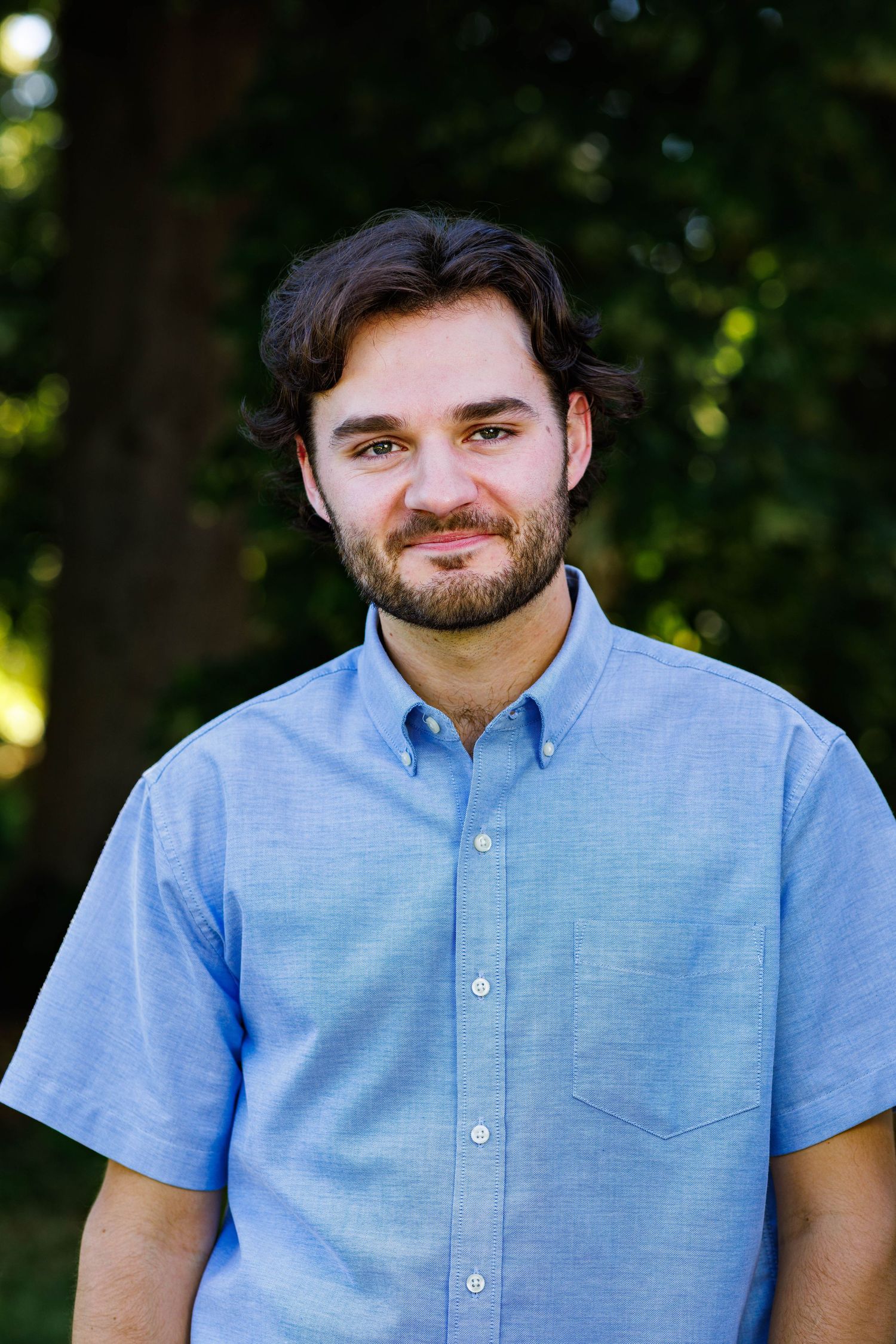 Relaxed, smiling portrait with park landscape at Rosamond Park