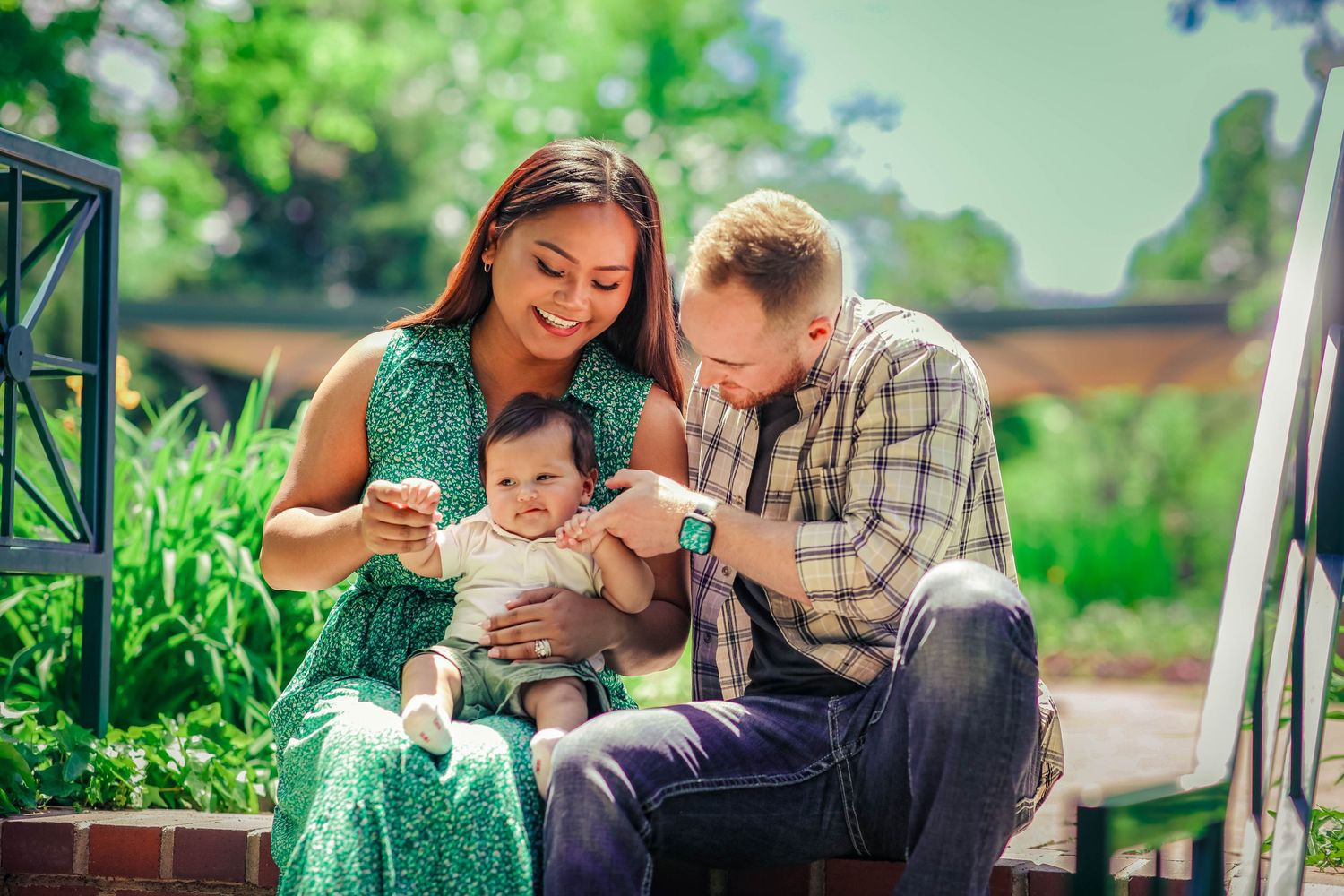 Couple embracing their child during sunset at the Denver Botanic Gardens