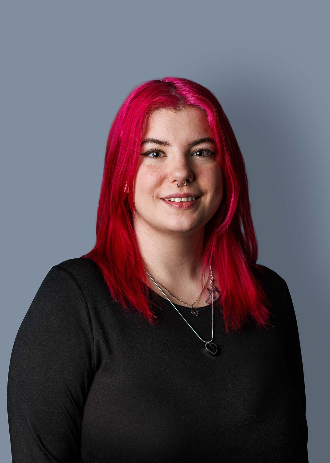 Professional Headshot portrait, with plain gray background for resume and LinkedIn Profile