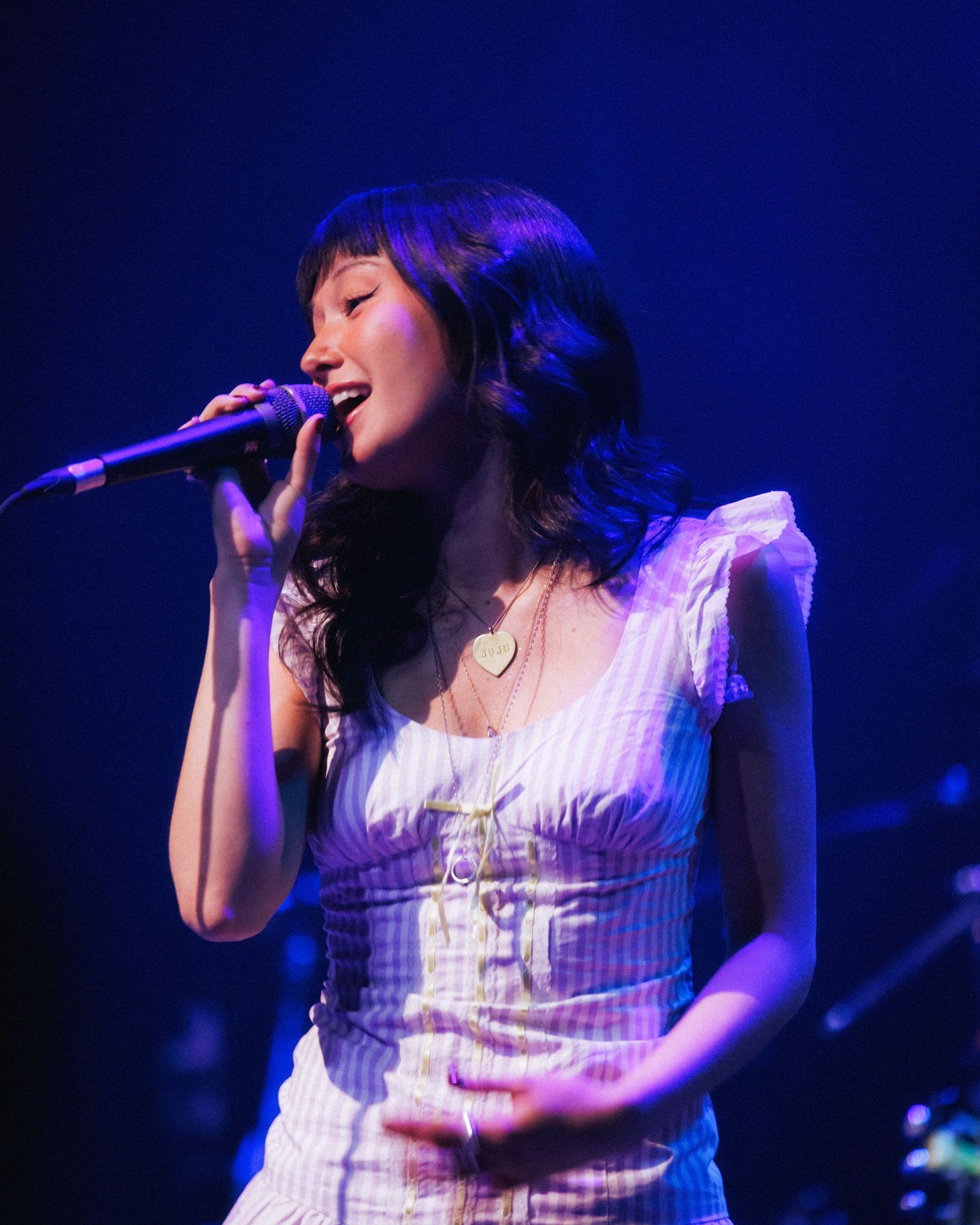 Close up of Juliet Ivy performing at the opener for mxmtoon, Liminal Space Tour at Gothic Theater in Denver, Colorado