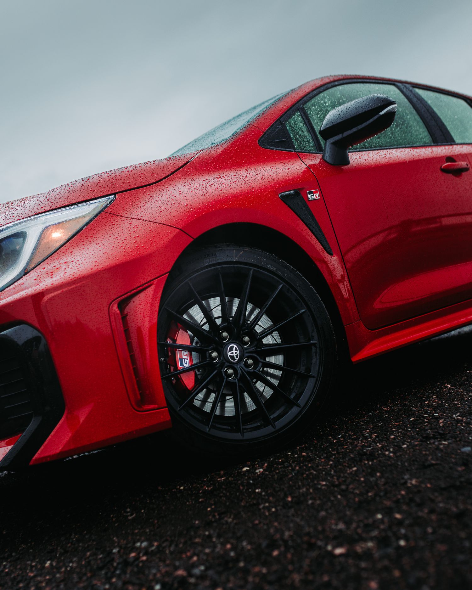 Close up detail shot of a Red GR Corolla wheel during a rain storm