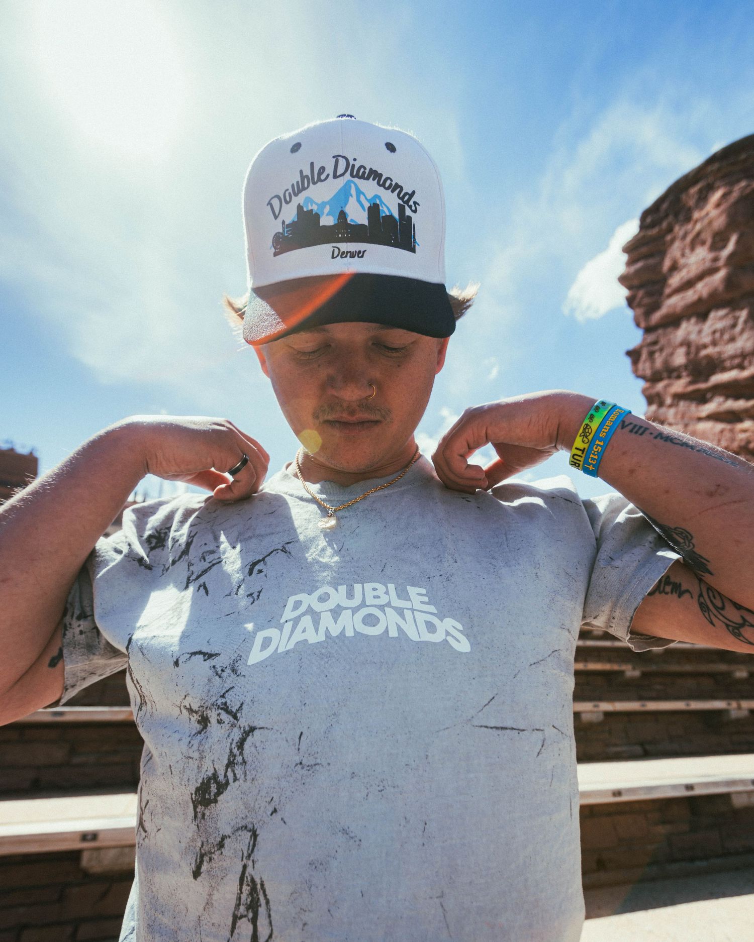 Portrait of model at Red Rocks, mid day, promoting local Denver, Colorado brand, Double Diamonds. Wearing a double diamonds shit and hat