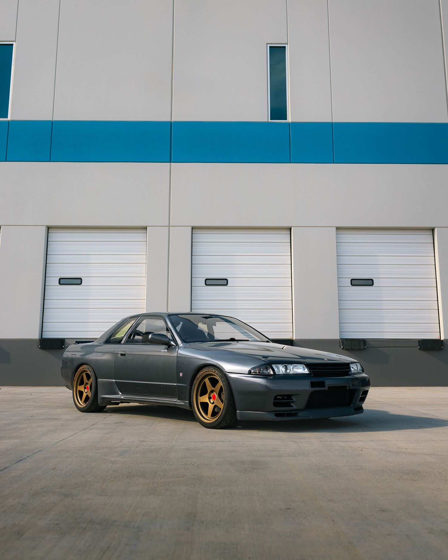 Medium shot of 1990 Nissan Skyline GTR R32 at a warehouse parking lot near Deer Creek Canyon in Denver, Colorado