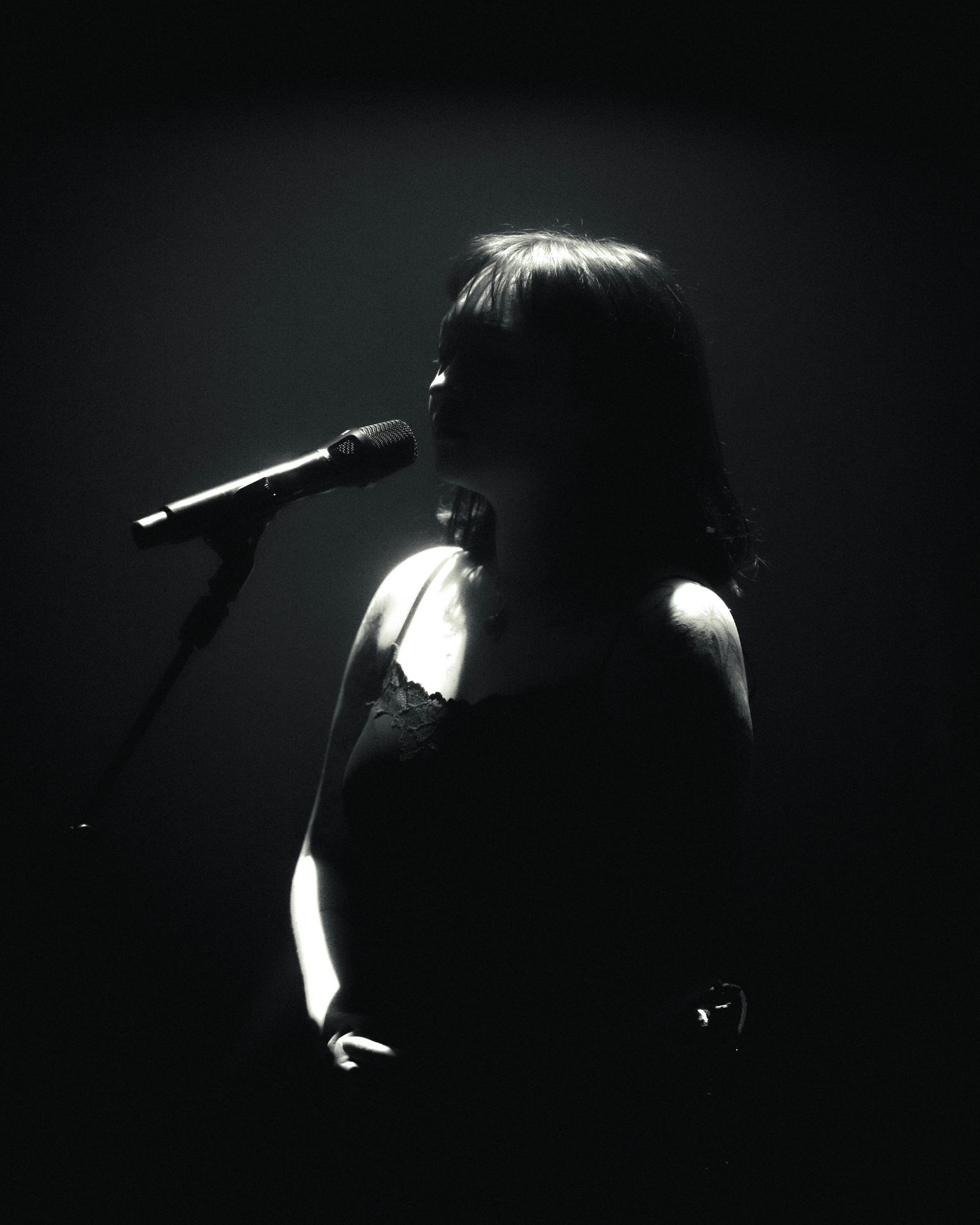 Creative black and white close up photo of mxmtoon, with performing on her Liminal Space Tour at Gothic Theater in Denver, Colorado