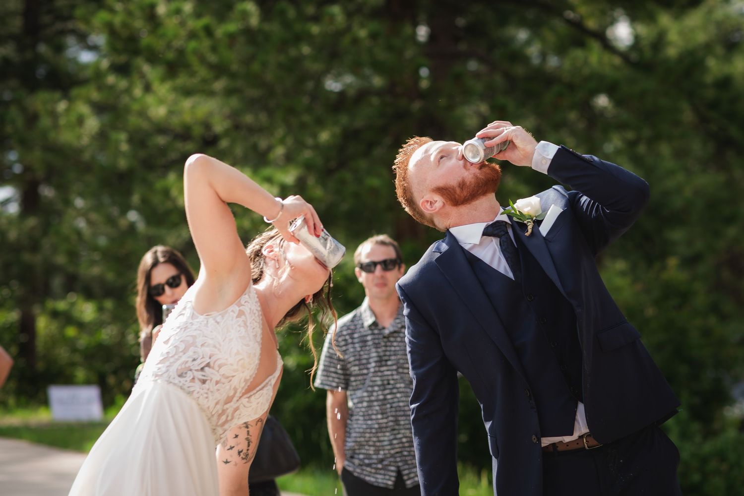 Wolfe Wedding in Franktown, Colorado, newly weds shotgunning a beer together after vows