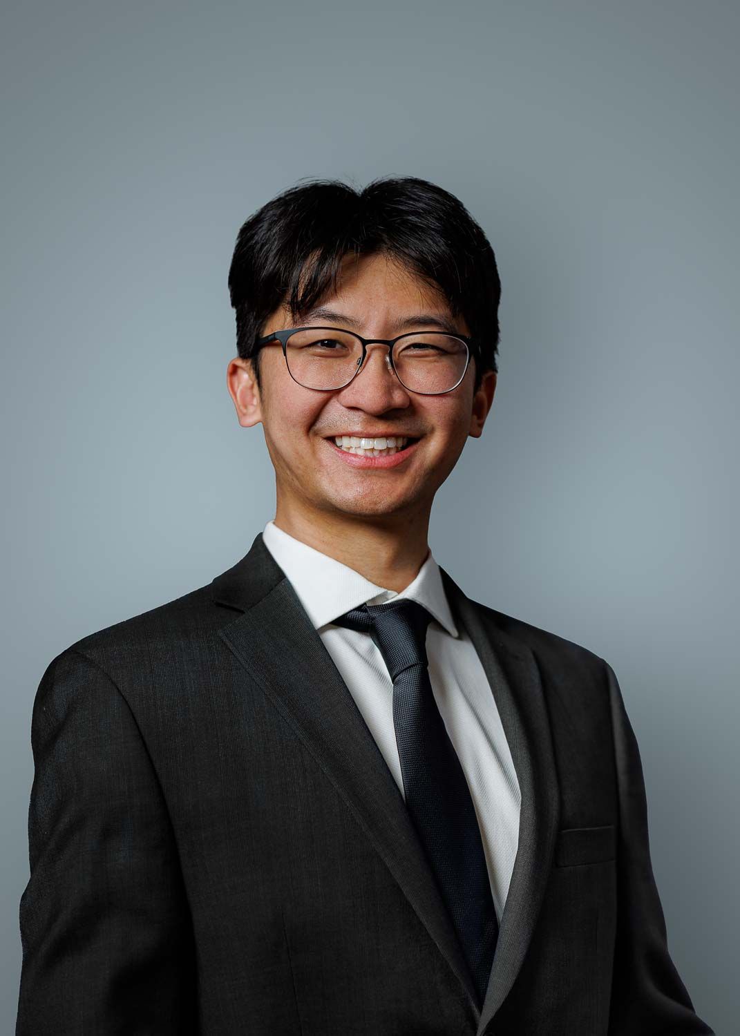 Professional Headshot portrait, with plain gray background for resume and LinkedIn Profile