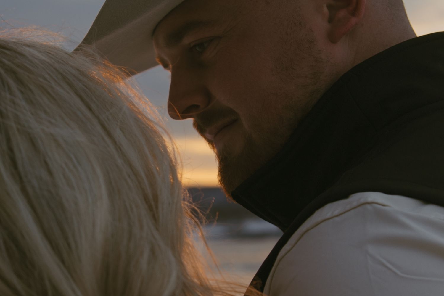 Cinematic winter western couple photo with the snowy mountains behind them, in Hudson valley New York