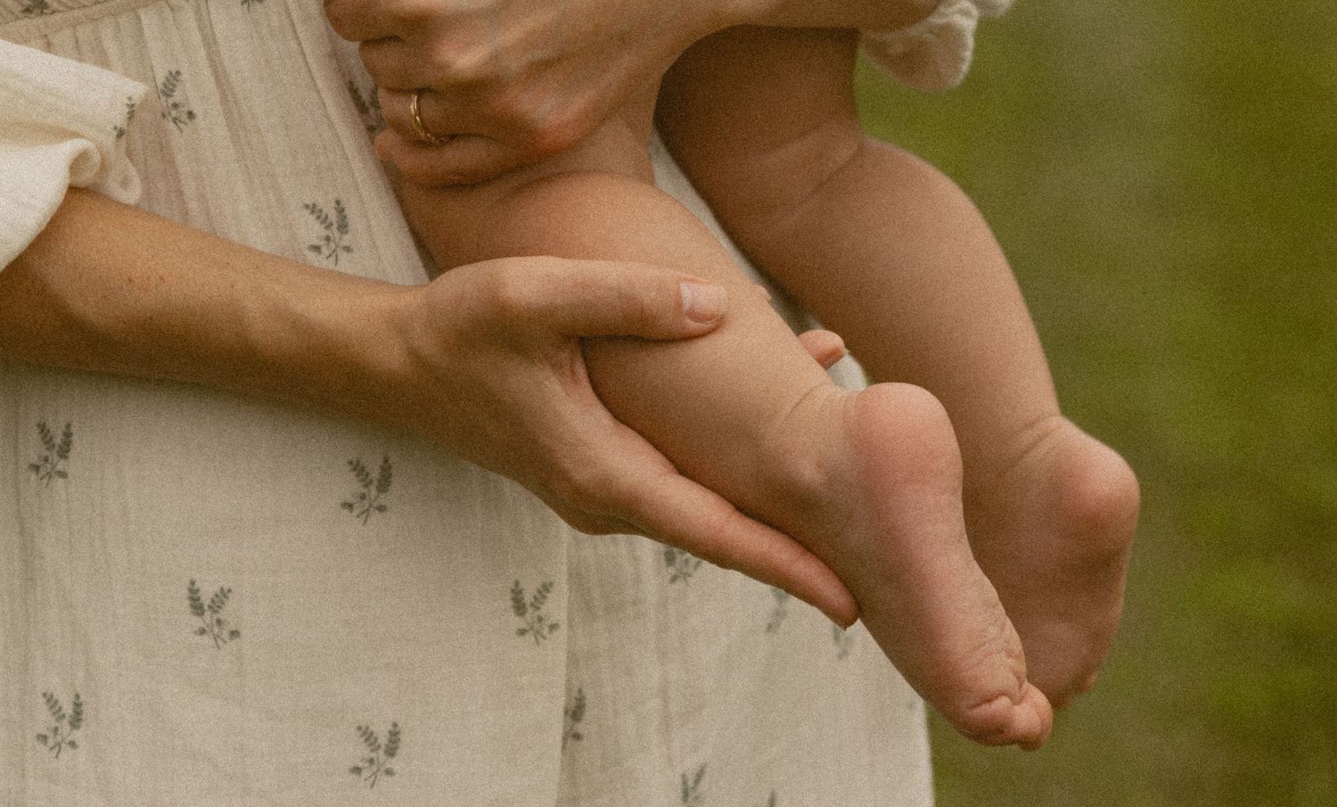 A candid motherhood photo of a mom holding her child's feet, in Milford, Pennsylvania.