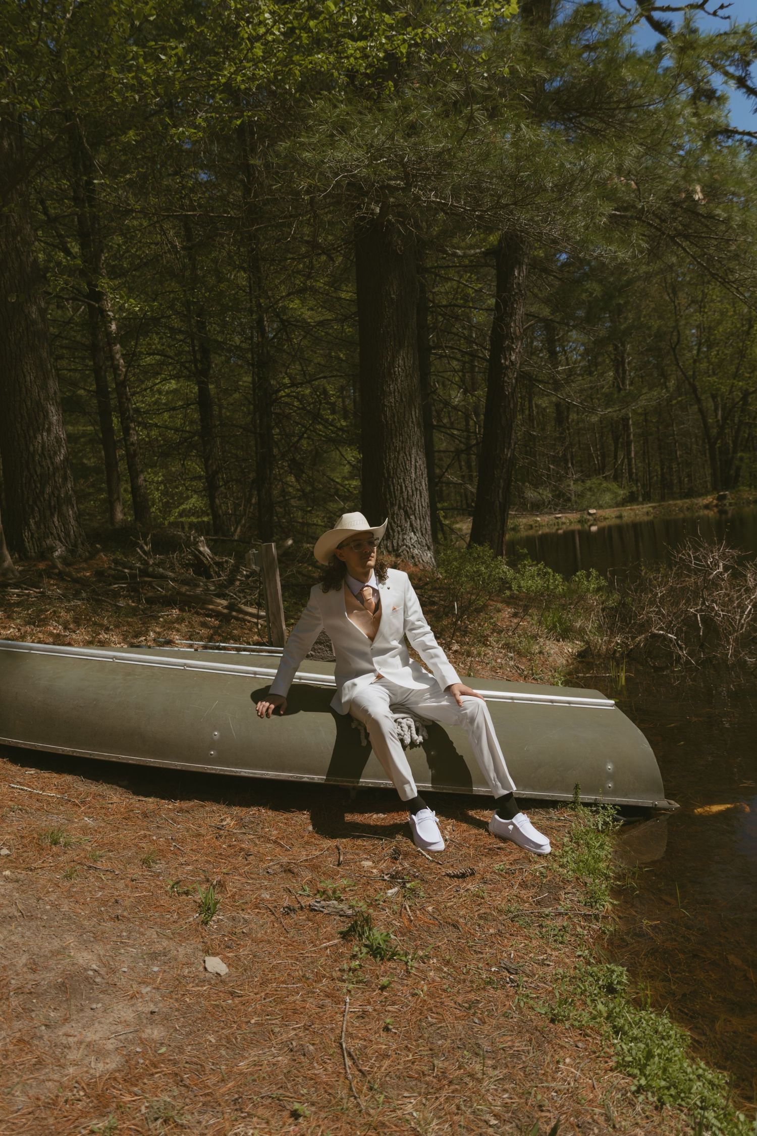 Deleware River portrait session with a boat next to a pond in the woods in the Catskill Mountains of New York