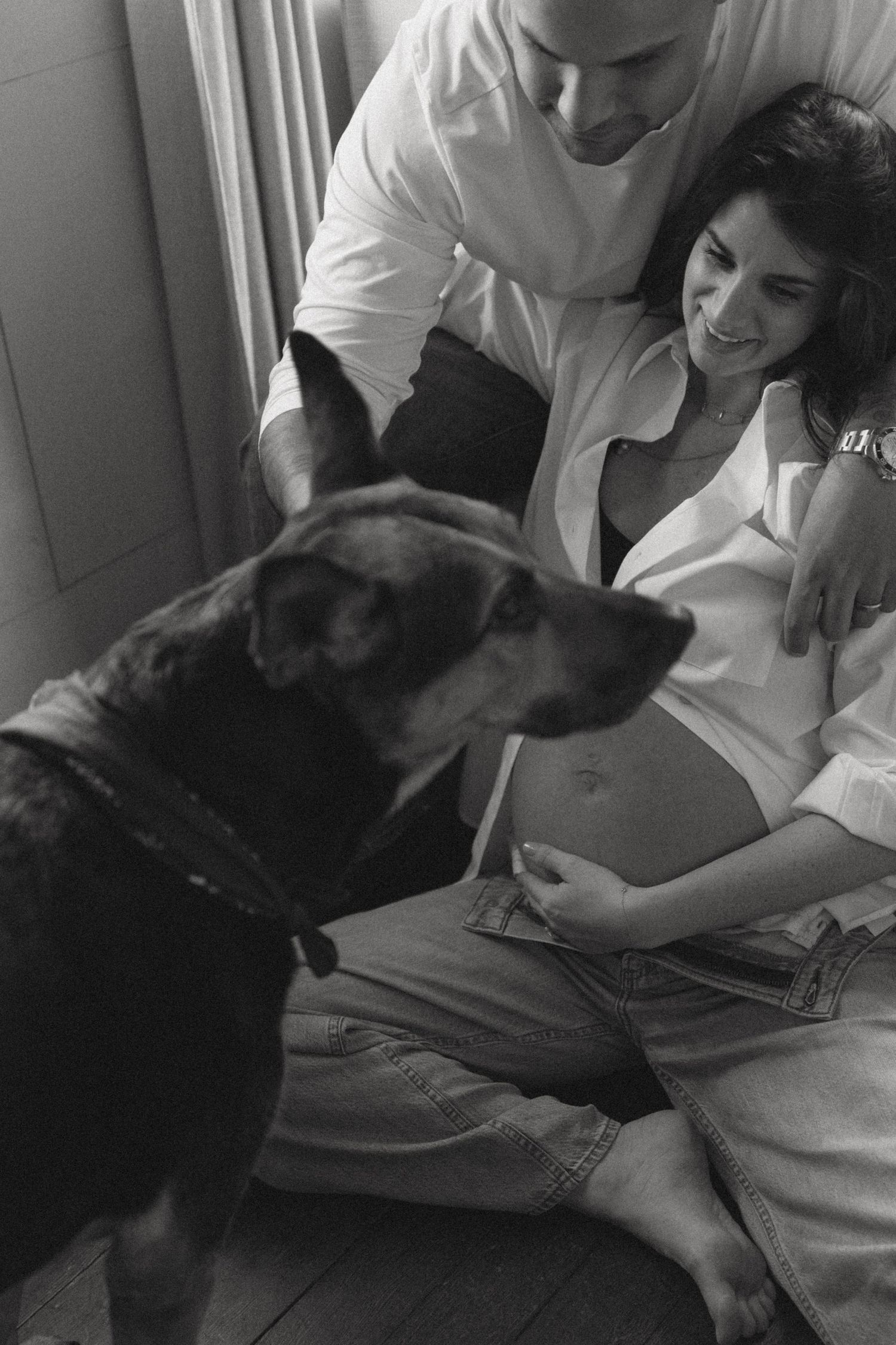 Cozy Editorial indoor maternity photos in the sleepy pine cottage at Cedar Lake Estates in Port Jervis, New York. Photo with dog near window