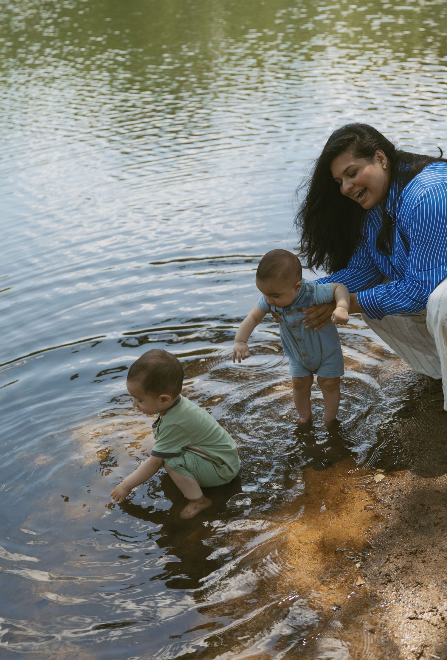 Motherhood photos of a mom playing in the pond with her two kids in Sussex County New Jersey.