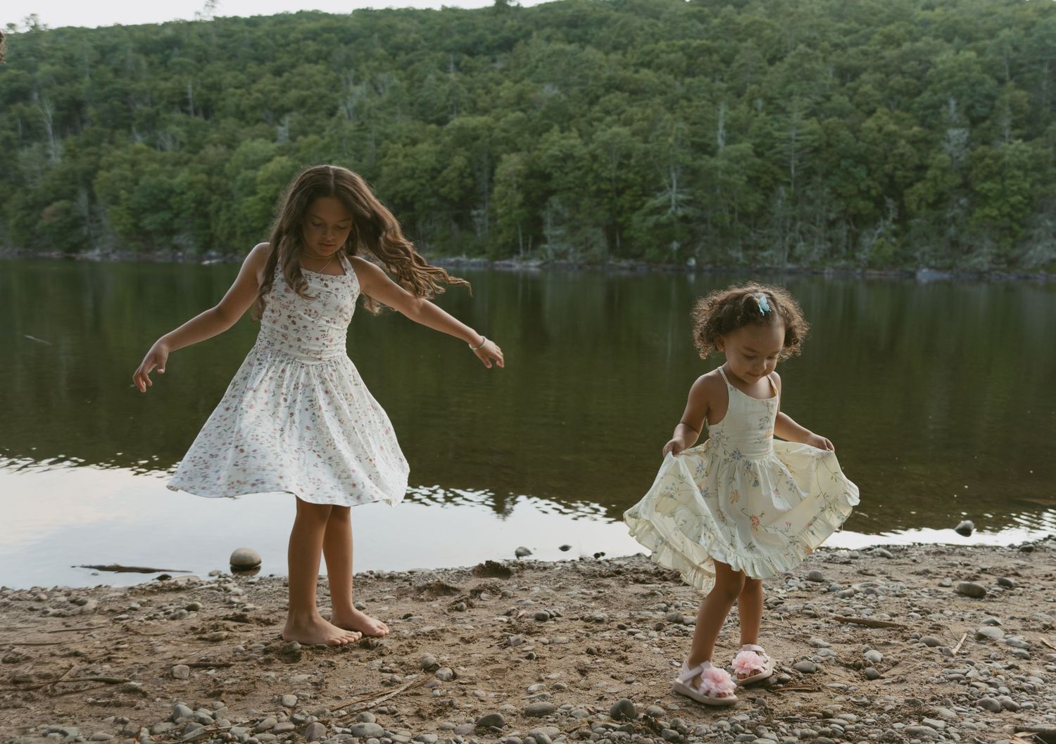 Sullivan County New York, Catskills. Family photo of daughters twirling next to the water