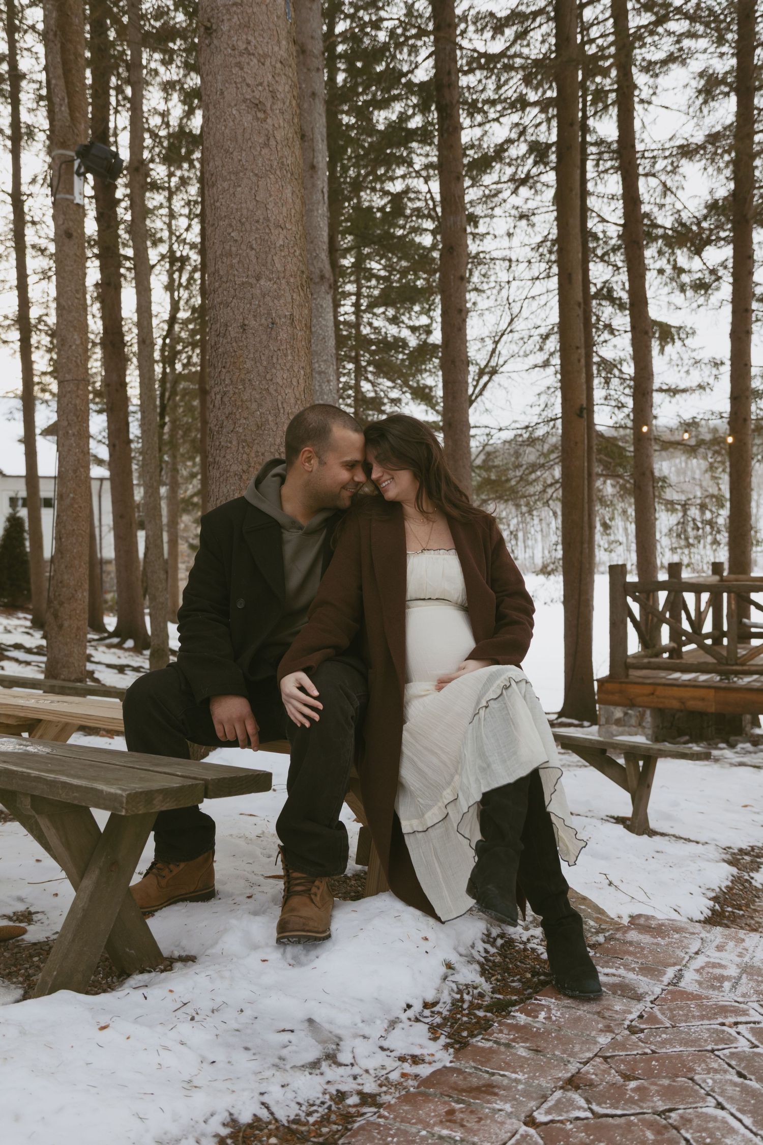 Cozy Editorial indoor maternity photos in the amphitheater at Cedar Lake Estates in Port Jervis, New York. Sitting on benches under trees.