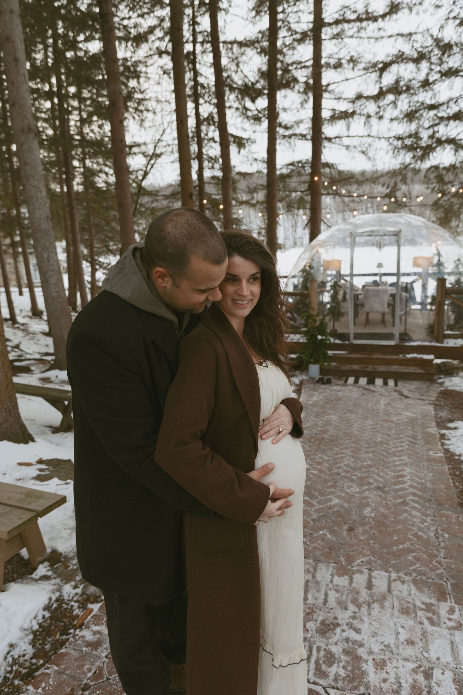 Editorial indoor maternity photos at the amphitheater at Cedar Lake Estates in Port Jervis, New York. Under the pine trees holding baby bump