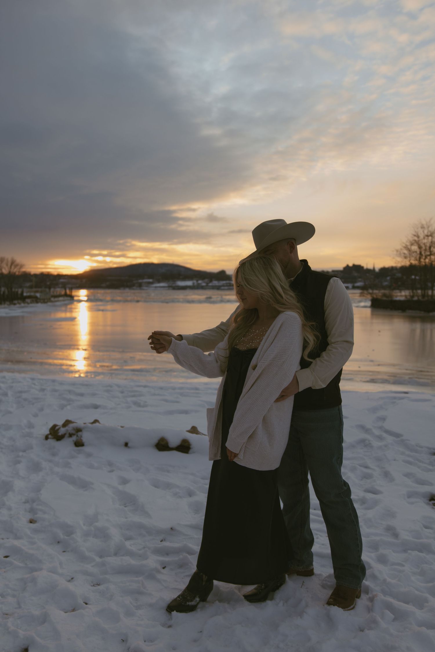 Cinematic winter western couple photo with the snowy mountains behind them, in Hudson valley New York