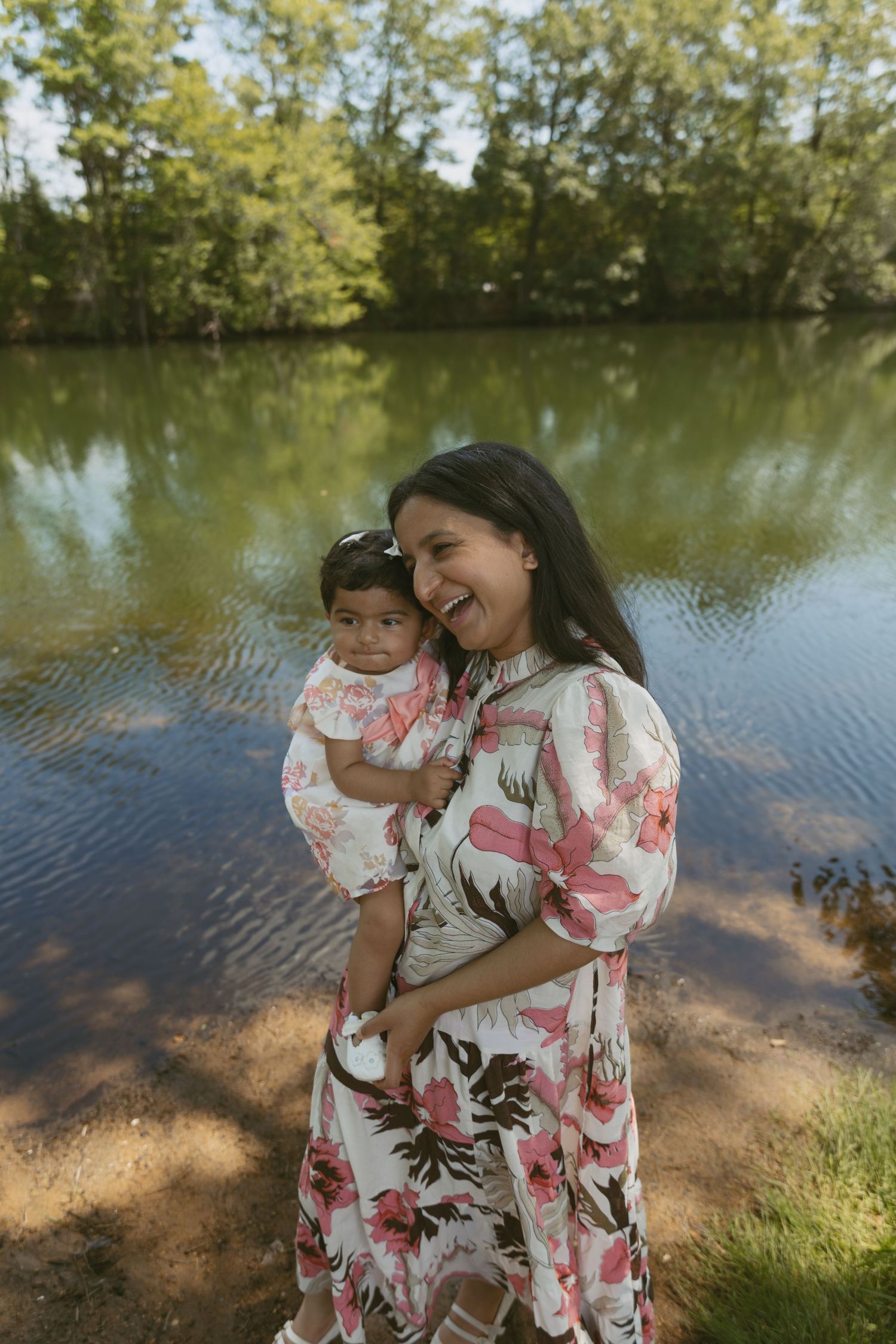 A motherhood photo of a mom holding her toddler at a pond in Sussex County New Jersey.