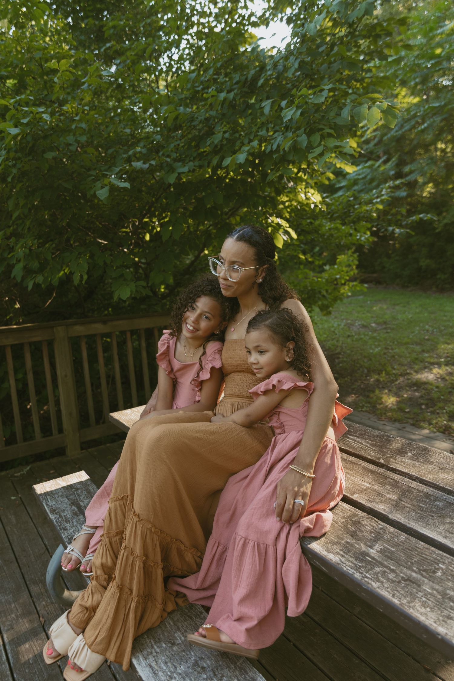 Motherhood photos of a mom with her two children, sitting on a picnic table in Orange County, New York.