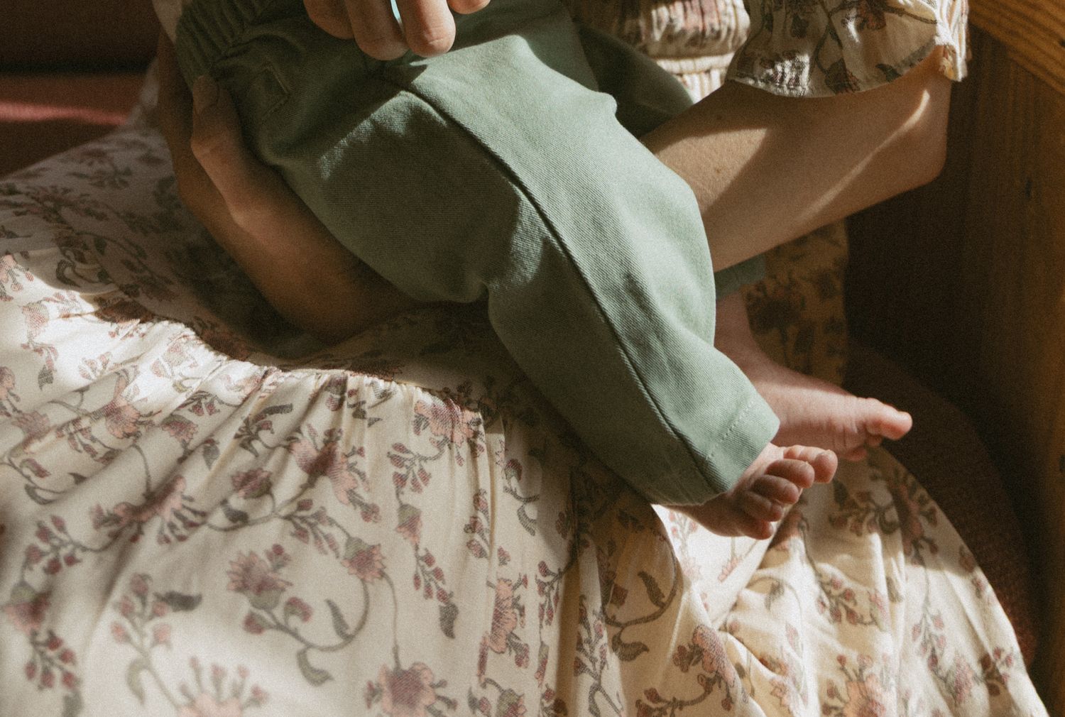 Newborn photos in family cabin in Sullivan County New York. Emotive Image of newborns feet in the sunlight coming through the window.