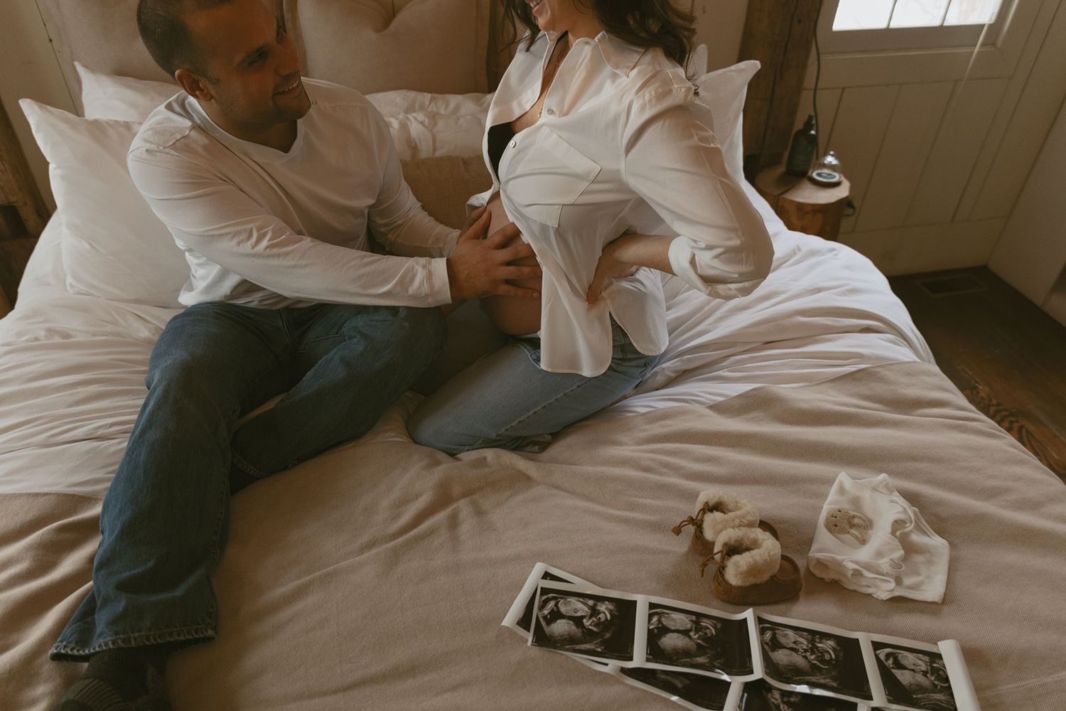 Cozy Editorial indoor maternity photos in the sleepy pine cottage at Cedar Lake Estates in Port Jervis, New York. Dad holding mom's bump